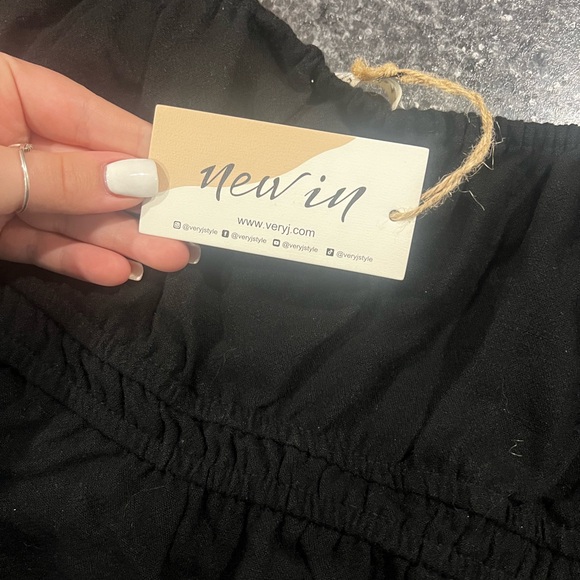 Black romper dress (short style) still has the tags on it. - Picture 2 of 2